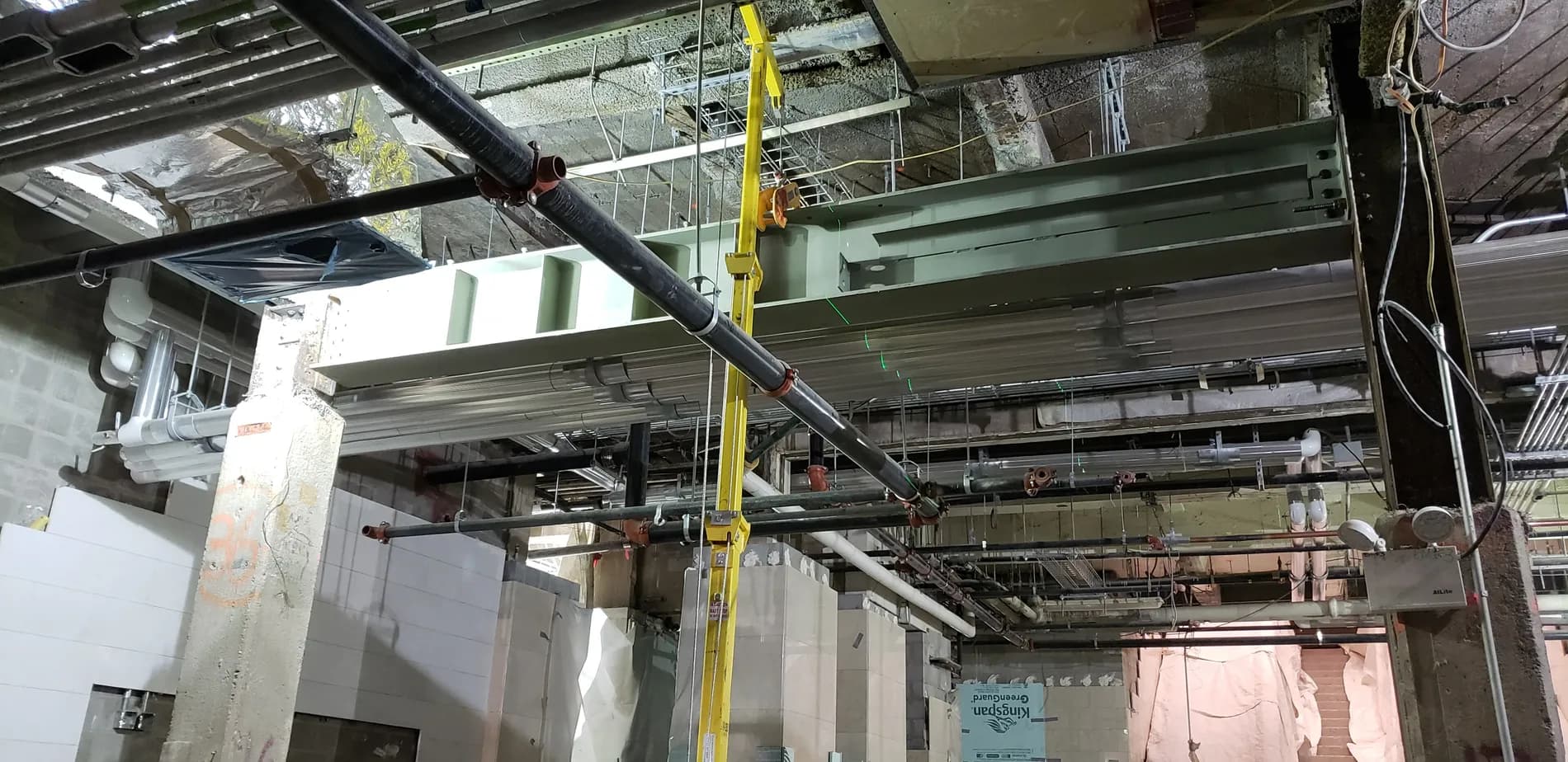 Ironworkers installing structural steel support beams on site