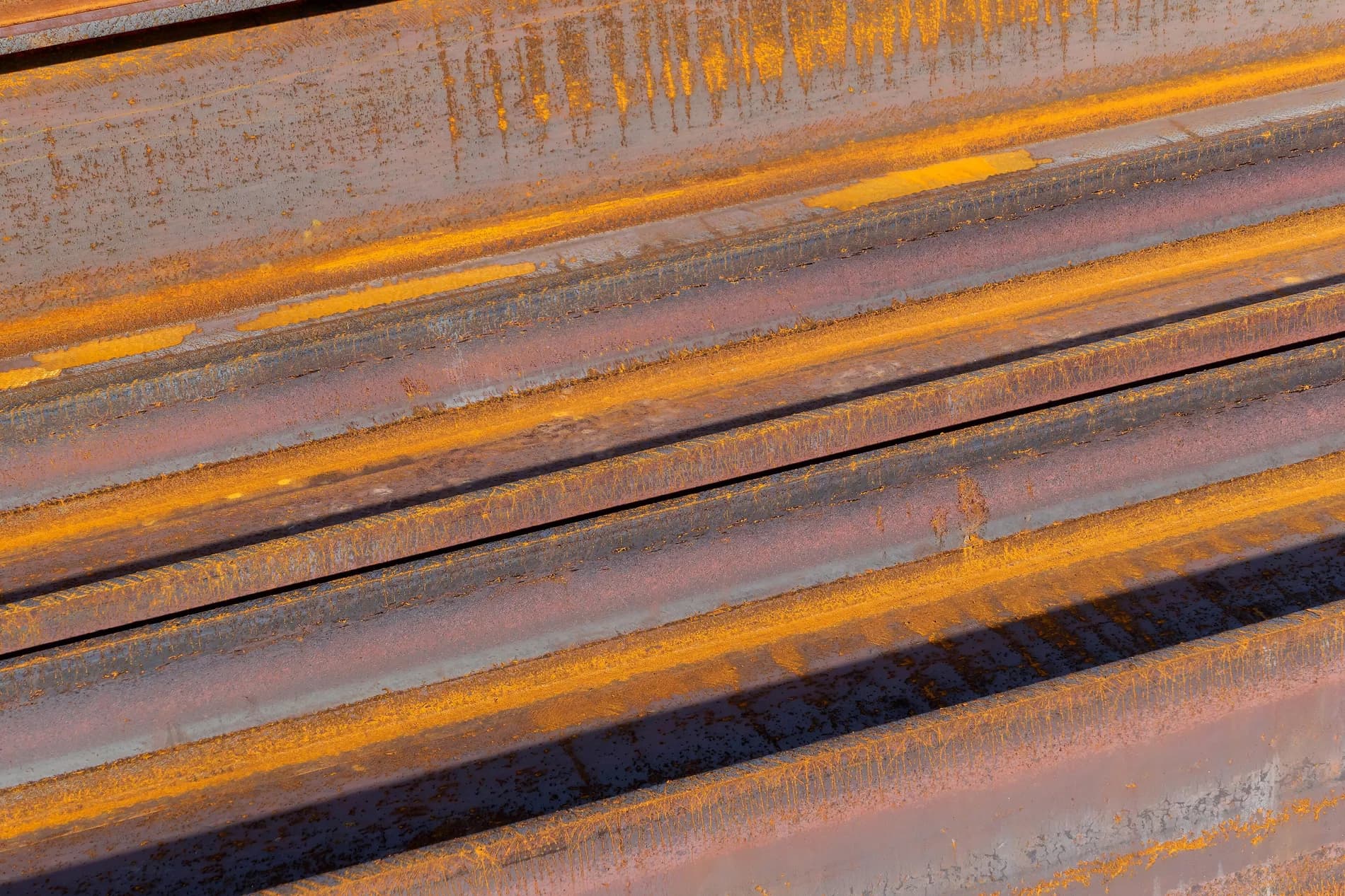 Rolled steel I-beam sections stacked as raw material
