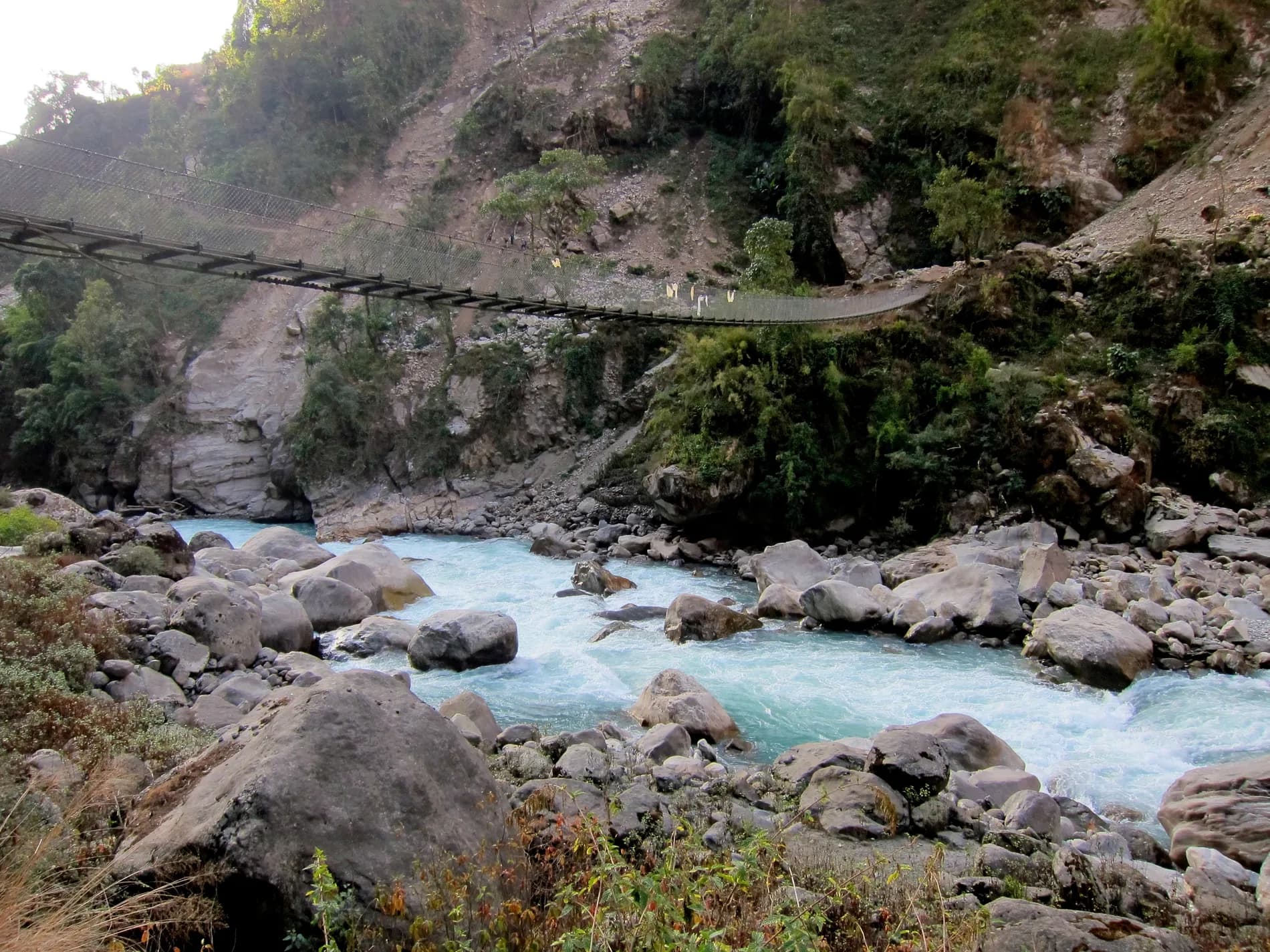 Steel pedestrian suspension bridge over a river gorge, Annapurna, Nepal